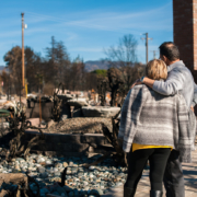 Man and his wife owners, checking burned and ruined house