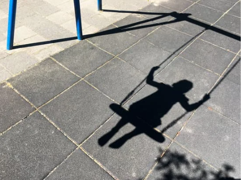 Shadow of a child on a swing